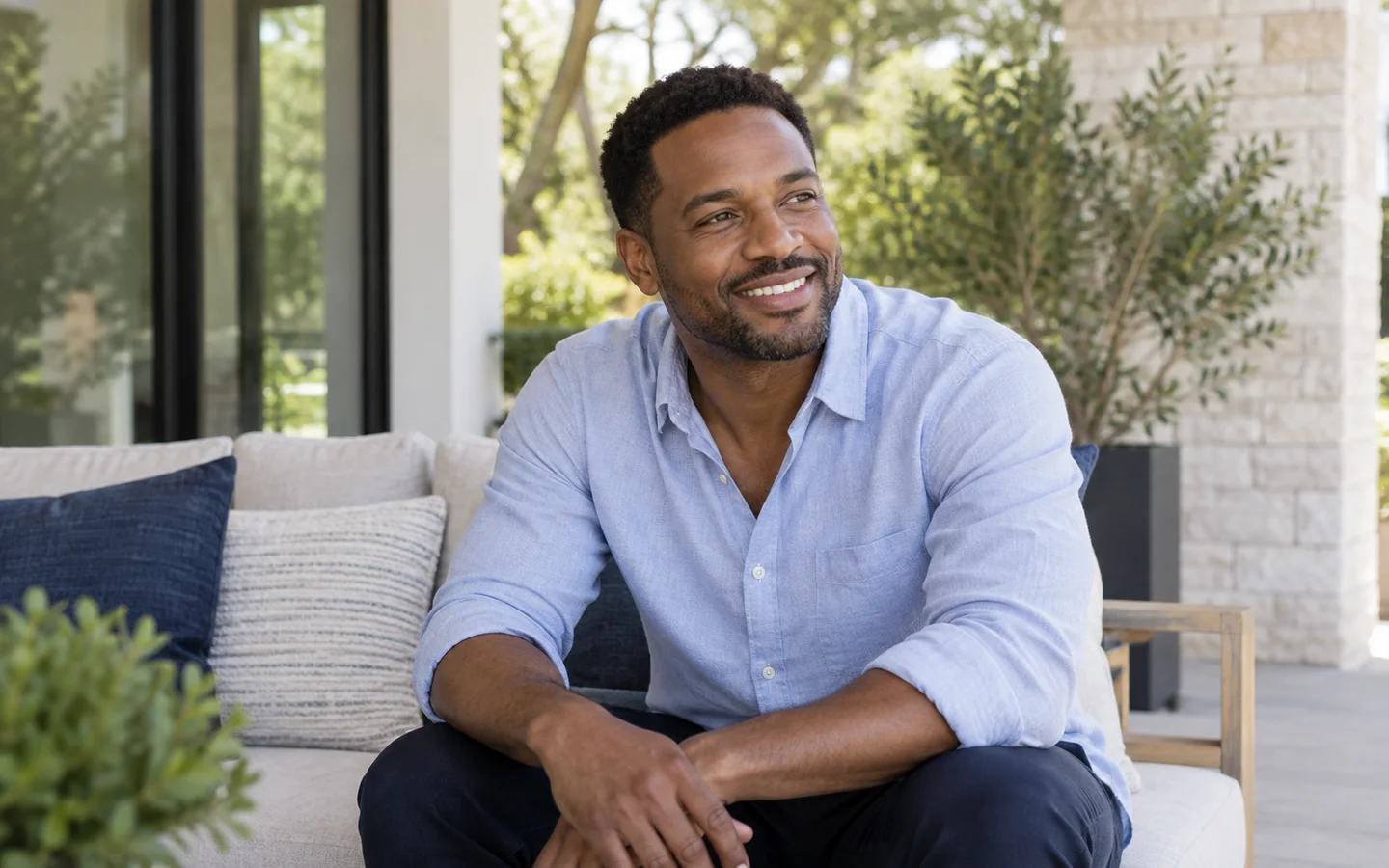 Man smiling on a shaded patio