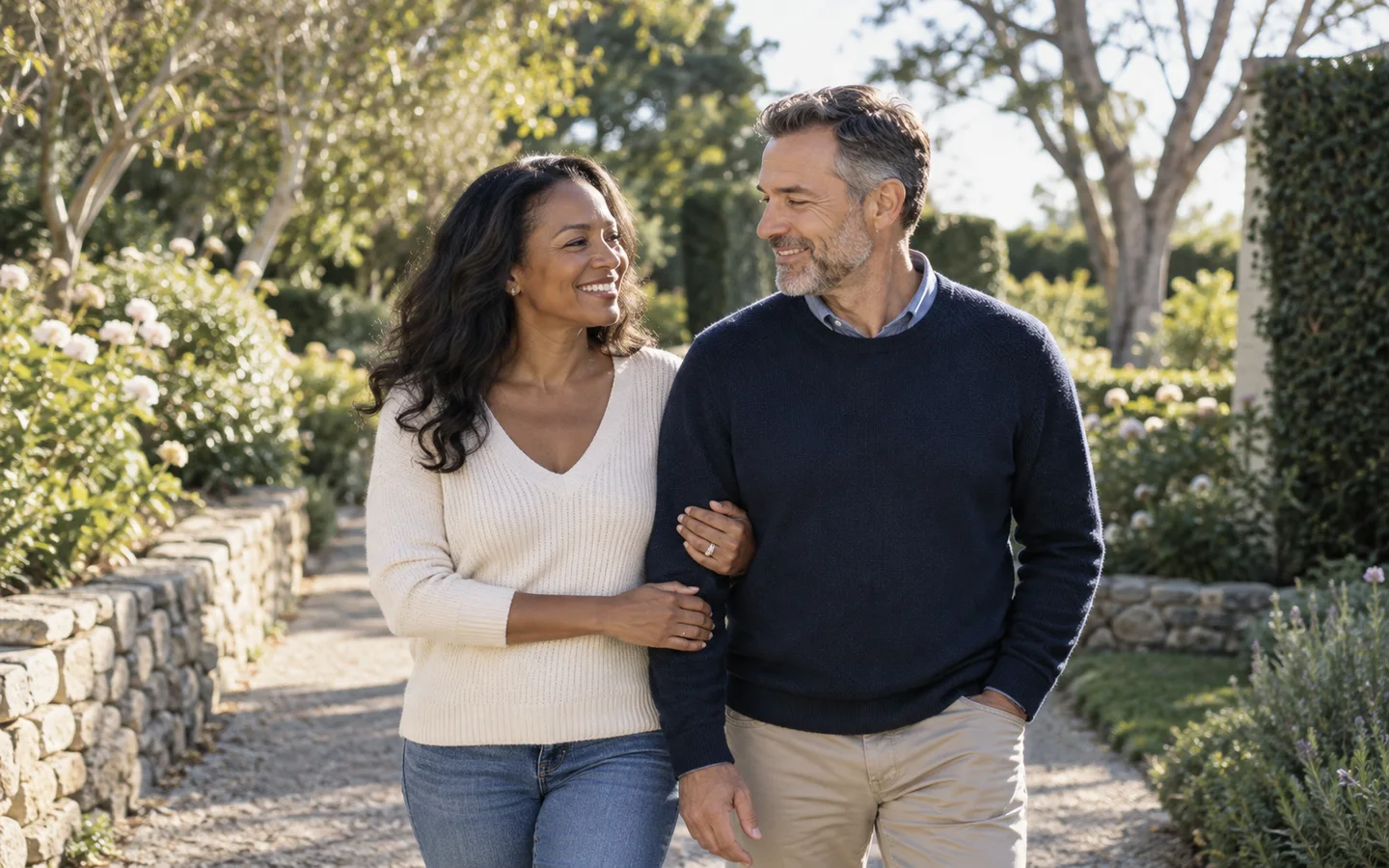 Couple walking together on a garden path