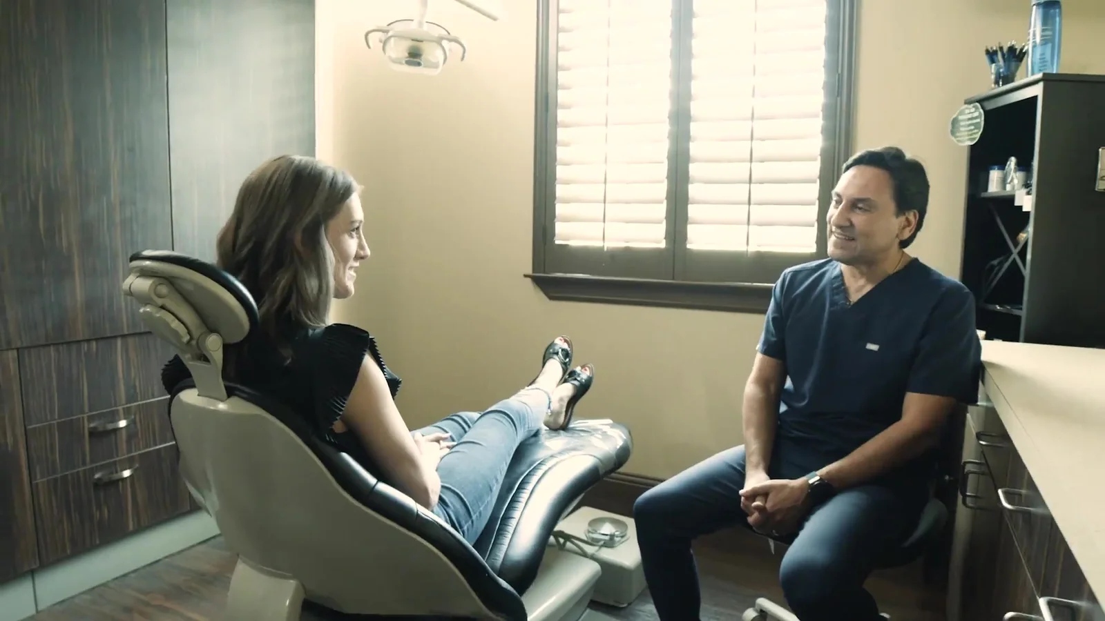 Dr. Ernest De Paoli talking with a patient at Advanced Smiles